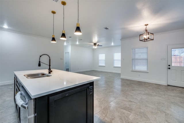 kitchen featuring a center island with sink, crown molding, sink, and pendant lighting