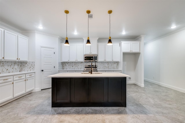 kitchen with stainless steel appliances, white cabinetry, and pendant lighting