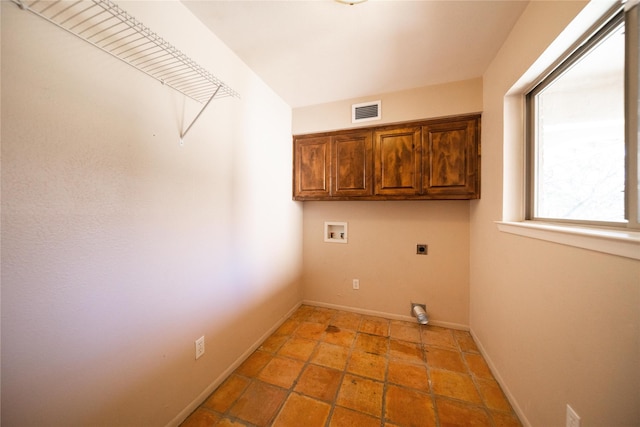 clothes washing area with hookup for a washing machine, cabinets, and hookup for an electric dryer