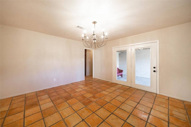 unfurnished room with a chandelier