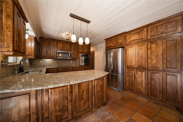 kitchen with sink, hanging light fixtures, tasteful backsplash, kitchen peninsula, and stainless steel appliances