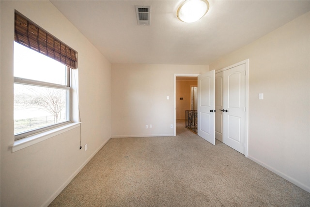 unfurnished room with light colored carpet