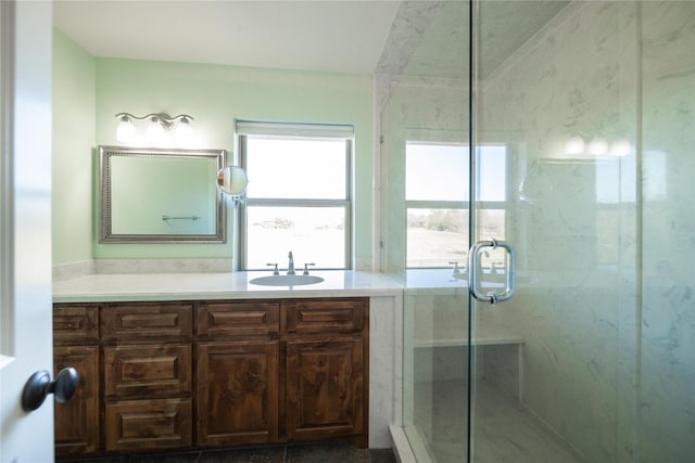 bathroom featuring vanity and a shower with shower door