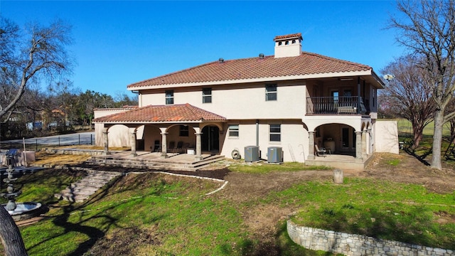 rear view of house featuring central AC, a balcony, and a patio