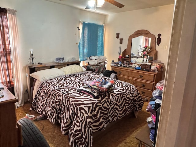 bedroom with ceiling fan and dark carpet