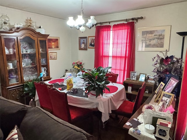 dining area featuring an inviting chandelier and ornamental molding