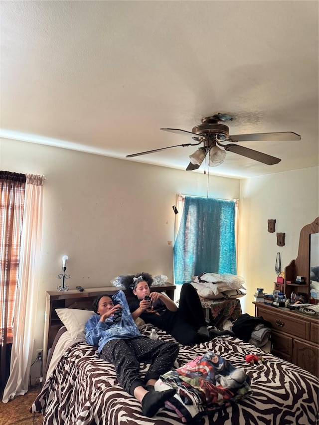 bedroom featuring ceiling fan and carpet floors