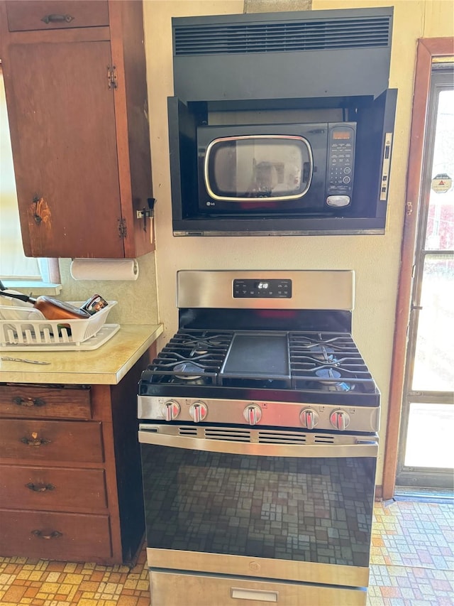 kitchen featuring a wealth of natural light and stainless steel gas stove