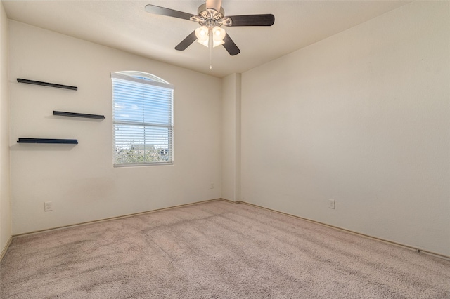 unfurnished room with light colored carpet and ceiling fan