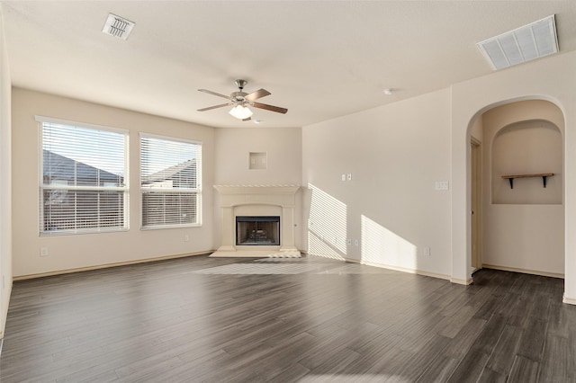 unfurnished living room with dark wood-type flooring and ceiling fan