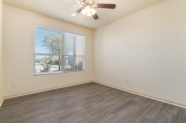 unfurnished room with dark hardwood / wood-style floors and ceiling fan