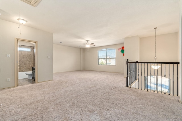 carpeted spare room with ceiling fan