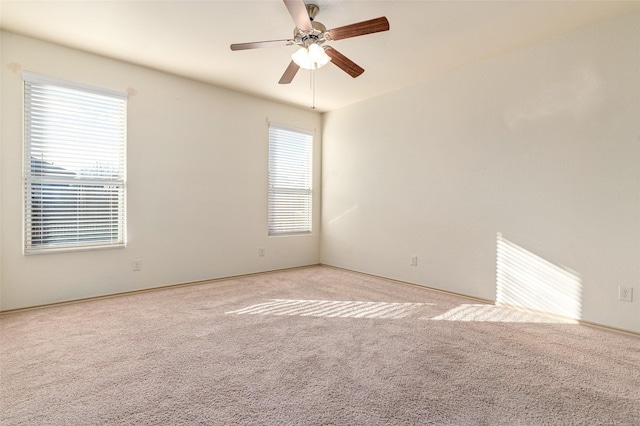 unfurnished room with ceiling fan and light carpet