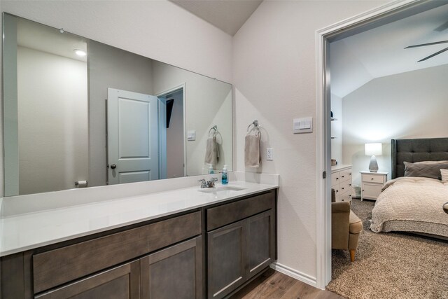 bathroom featuring vanity, lofted ceiling, hardwood / wood-style floors, and ceiling fan