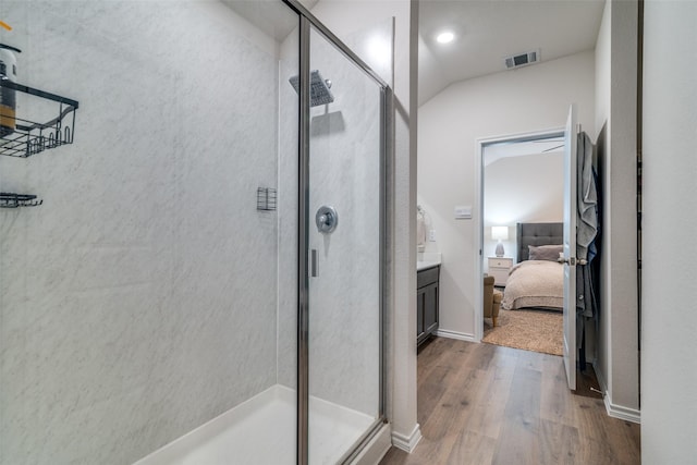 bathroom featuring walk in shower and wood-type flooring