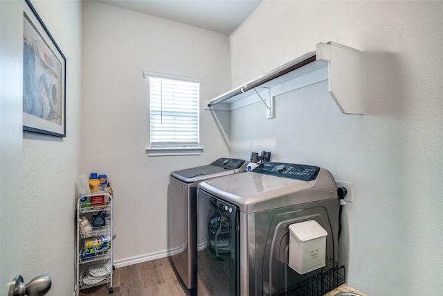 laundry area featuring hardwood / wood-style floors and washing machine and dryer