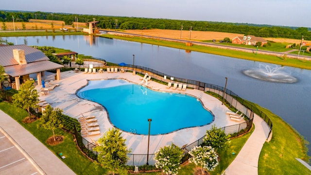 view of pool with a water view and a patio area