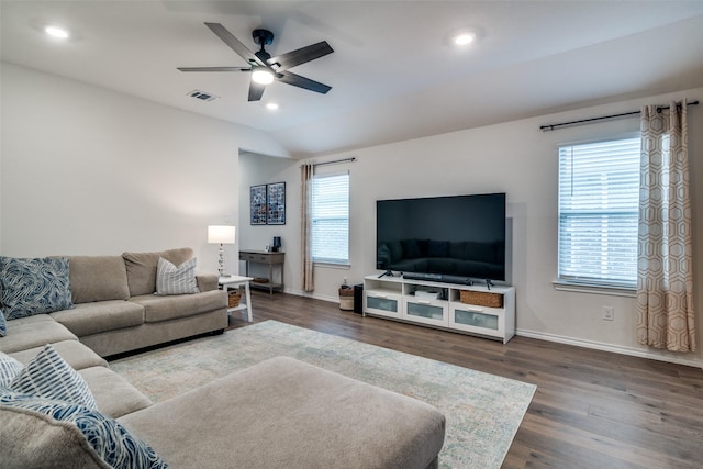 living room featuring dark hardwood / wood-style flooring, lofted ceiling, and ceiling fan