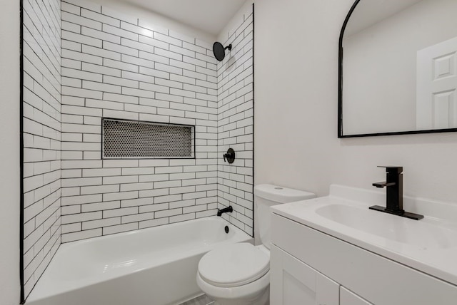 full bathroom featuring vanity, toilet, and tiled shower / bath