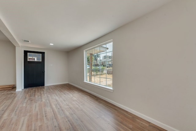 entrance foyer with light hardwood / wood-style flooring and baseboard heating