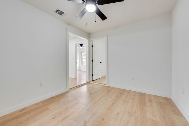 spare room with ceiling fan and light wood-type flooring