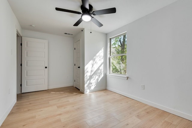 spare room featuring light hardwood / wood-style floors and ceiling fan