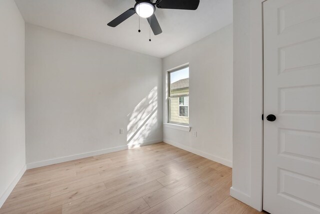 empty room with ceiling fan and light wood-type flooring