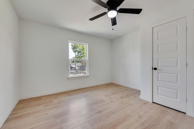 empty room with ceiling fan and light wood-type flooring