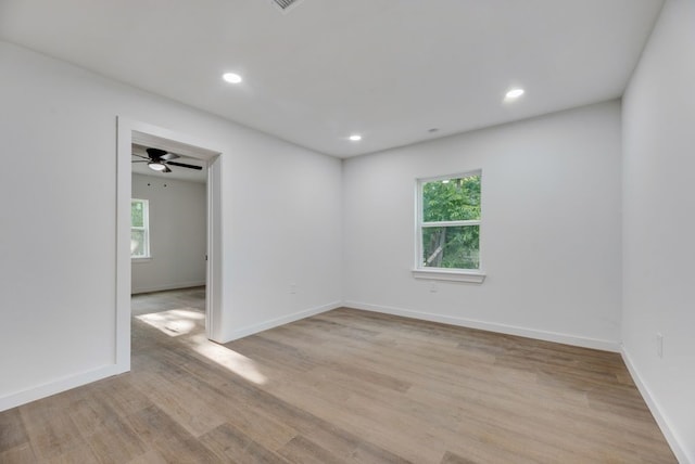 spare room with light hardwood / wood-style floors and ceiling fan