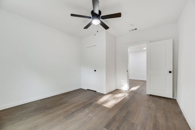 spare room featuring ceiling fan and dark hardwood / wood-style floors