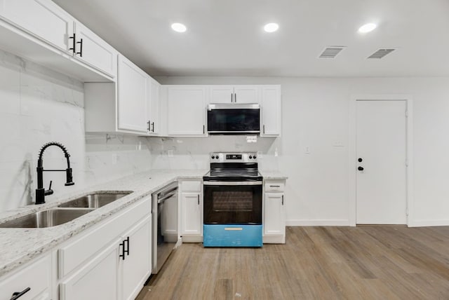 kitchen featuring white cabinetry, sink, and appliances with stainless steel finishes