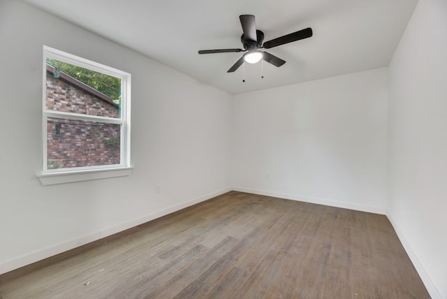 spare room with wood-type flooring and ceiling fan