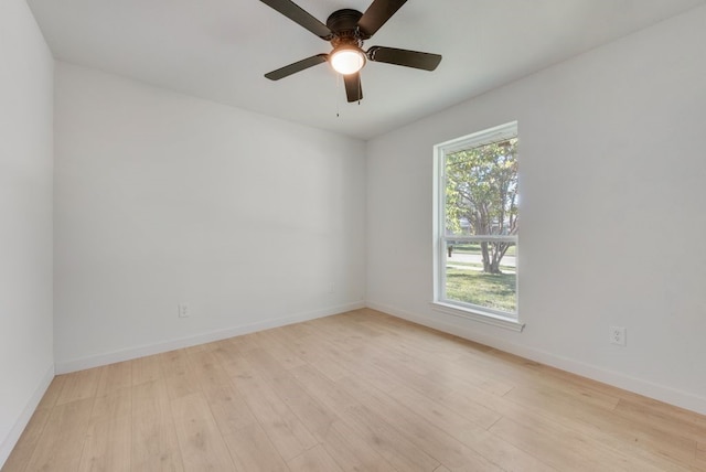 empty room with ceiling fan and light hardwood / wood-style flooring