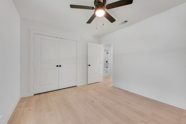 unfurnished bedroom with a closet, light hardwood / wood-style flooring, and ceiling fan