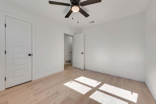 unfurnished bedroom with ceiling fan and light hardwood / wood-style flooring