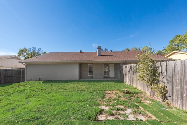 back of house with a lawn