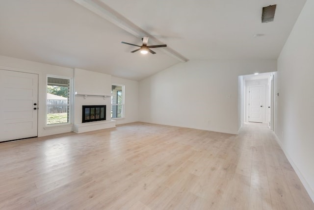 unfurnished living room featuring ceiling fan, light hardwood / wood-style flooring, and vaulted ceiling with beams