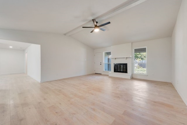 unfurnished living room with vaulted ceiling with beams, light hardwood / wood-style floors, a brick fireplace, and ceiling fan