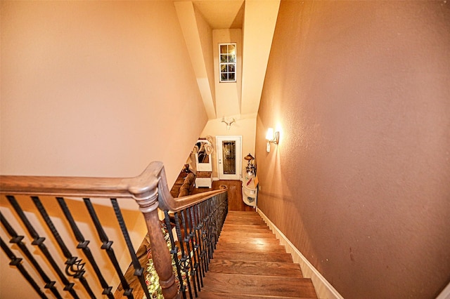 stairway featuring wood-type flooring