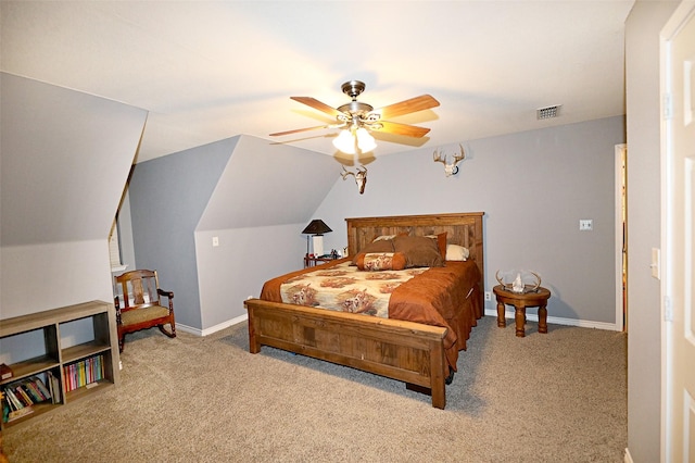 carpeted bedroom with ceiling fan and vaulted ceiling