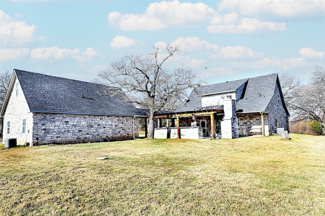 back of property with a yard and central air condition unit