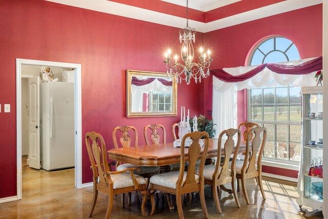 dining area with ornamental molding and an inviting chandelier