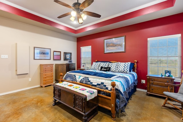 bedroom featuring ceiling fan, a raised ceiling, carpet floors, and crown molding