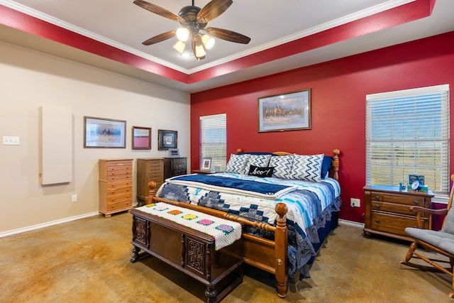 carpeted bedroom with crown molding, ceiling fan, a raised ceiling, and multiple windows