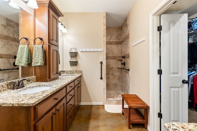 bathroom with vanity and tiled shower