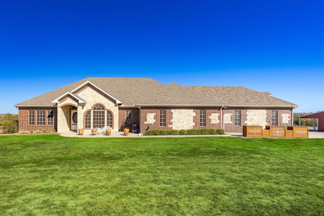 ranch-style home with a front lawn and a patio