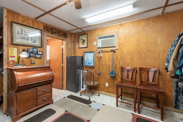 misc room featuring a wall mounted AC and wood walls