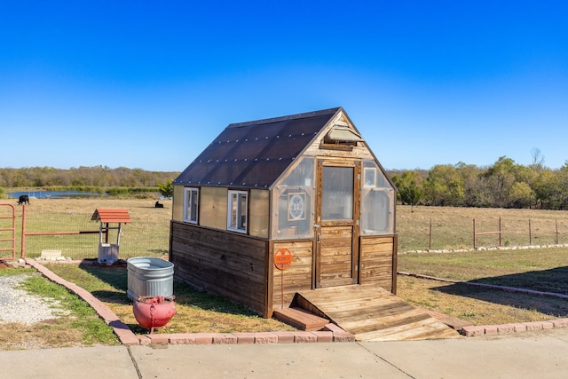 view of outdoor structure with a yard and a rural view