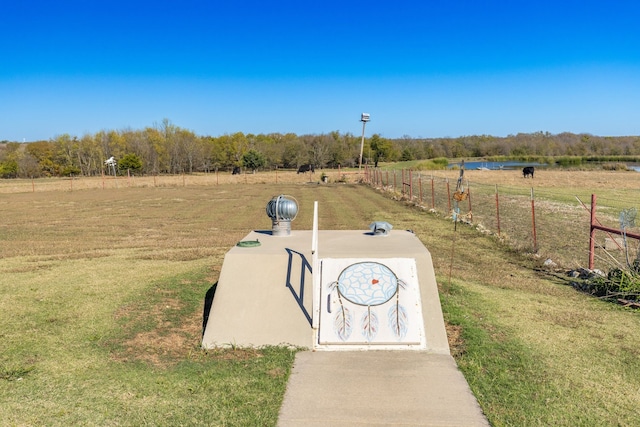 view of storm shelter featuring a yard and a rural view