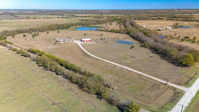 birds eye view of property featuring a rural view and a water view